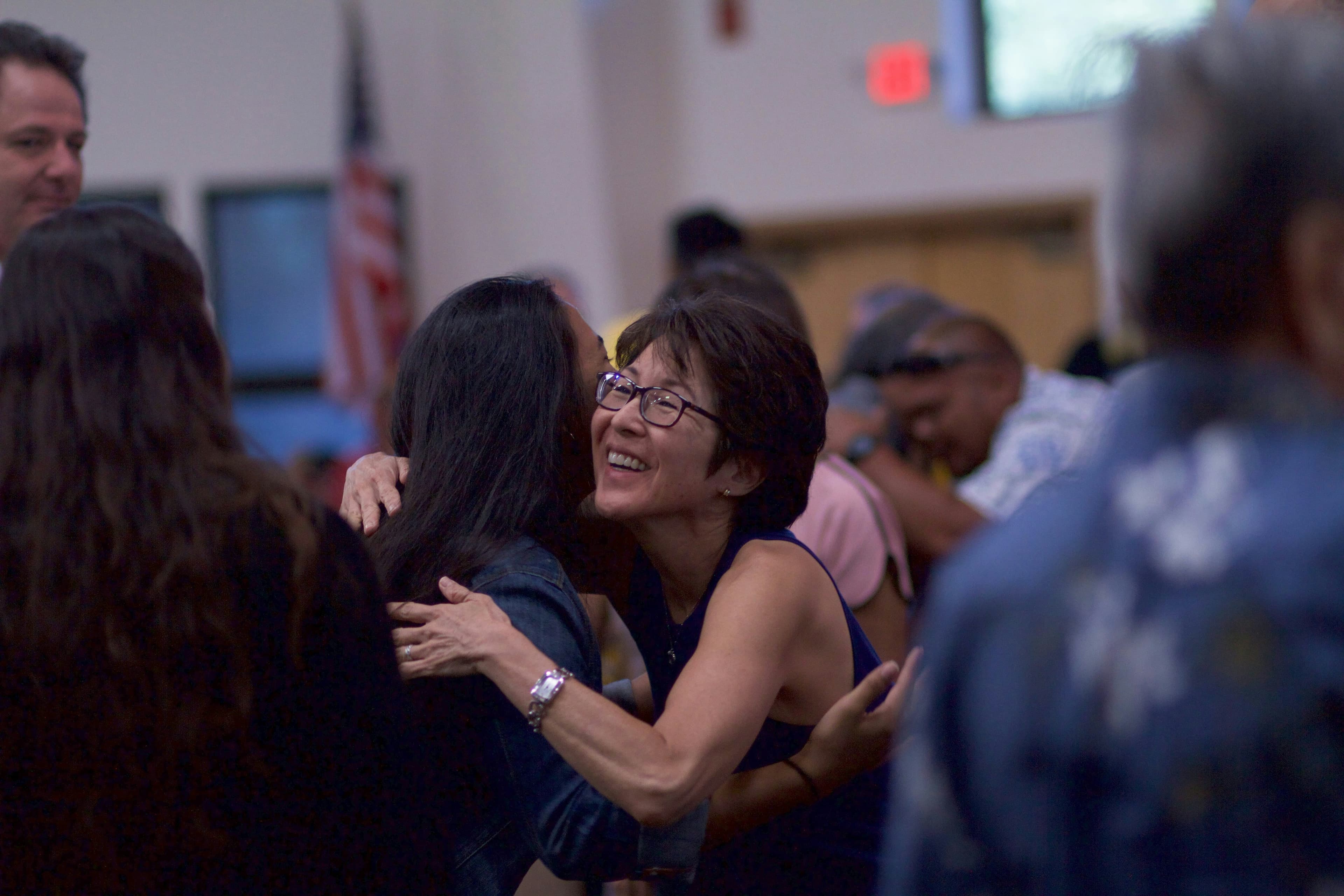 Two women embracing warmly at a church gathering